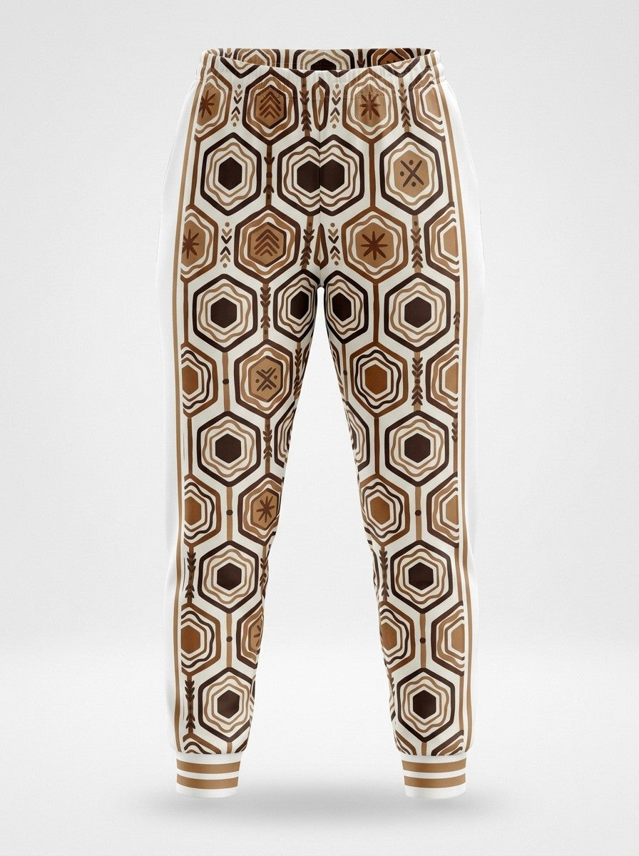 Ghost-mannequin front view of AnanseNova™ Women's Joggers in Ocha White, AnanseNova™ hexagon print across both legs with bronze-striped rib cuffs