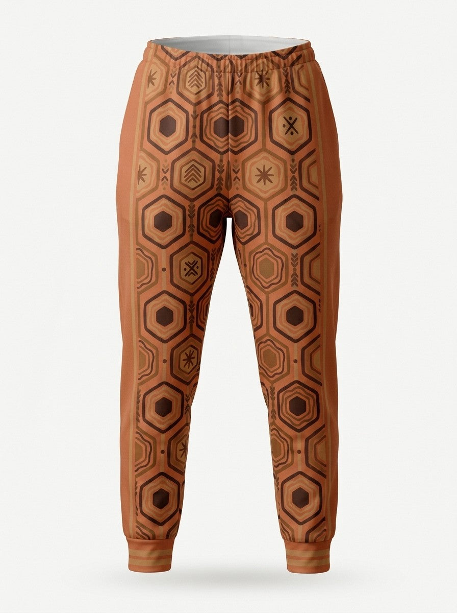 Ghost-mannequin front view of AnanseNova™ Women's Joggers in Sango Orange, AnanseNova™ hexagon print across both legs with bronze-striped rib cuffs