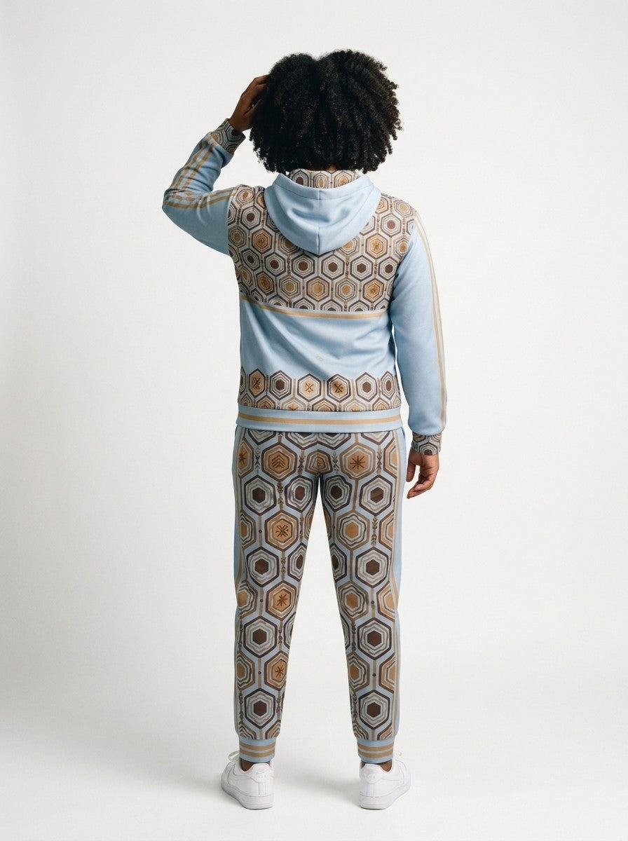Back view of the AnanseNova™ women's Zip Hoodie + Joggers set in Igwe Blue on model, hexagon back yoke, bronze sleeve stripes and printed joggers | SunBorn
