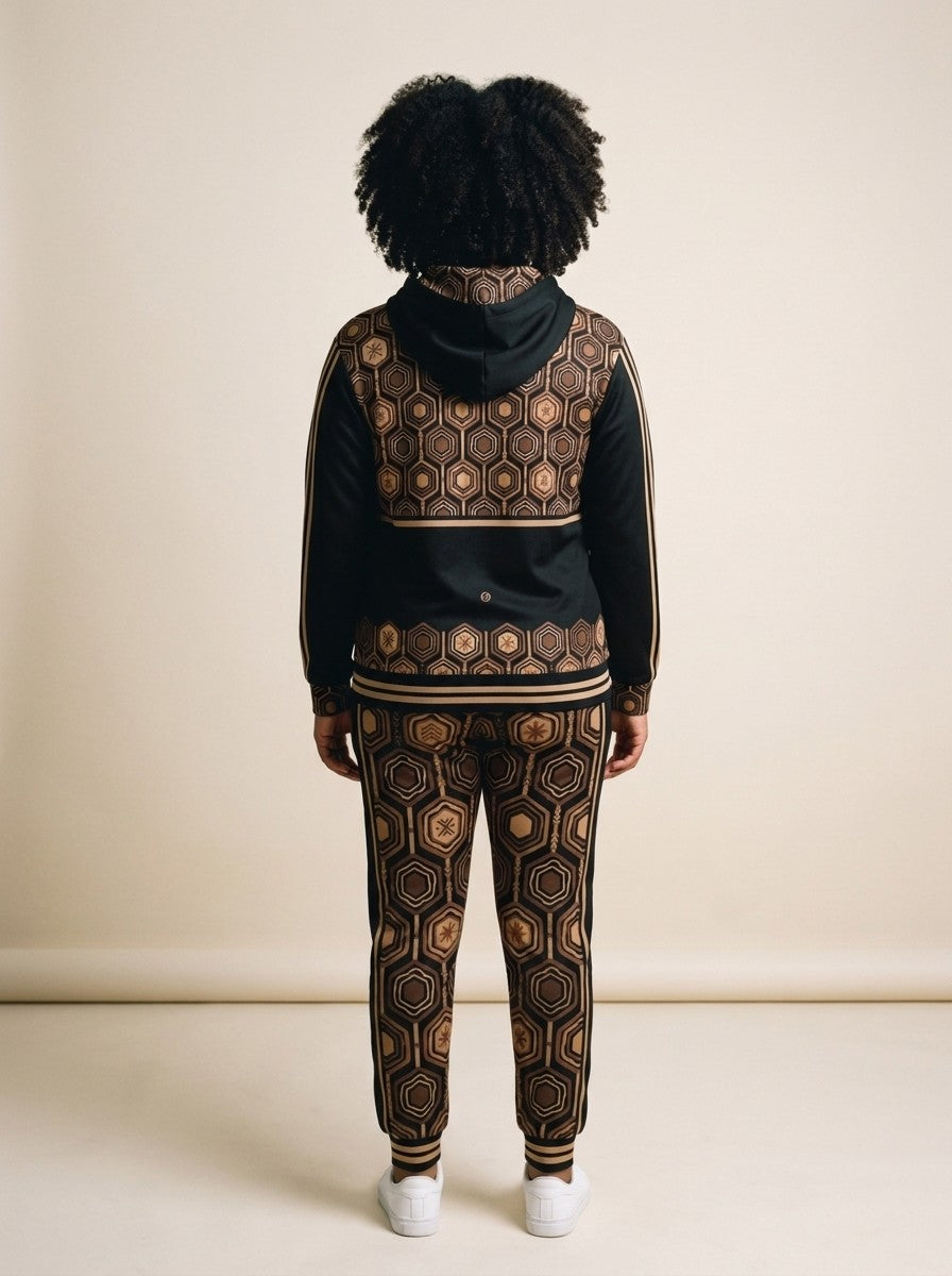 Back view of the AnanseNova™ women's Zip Hoodie + Joggers set in Oji Black on model, hexagon back yoke, bronze sleeve stripes and printed joggers | SunBorn