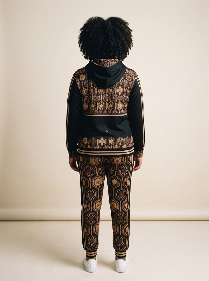 Back view of the AnanseNova™ women's Zip Hoodie + Joggers set in Oji Black on model, hexagon back yoke, bronze sleeve stripes and printed joggers | SunBorn