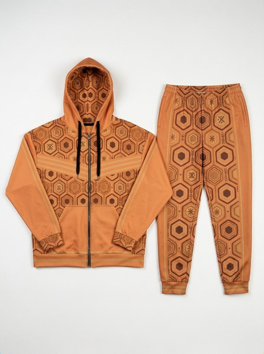 Flat lay of the Sango Orange AnanseNova™ women's Zip Hoodie and Joggers side by side, showing the printed hood lining, chest web and full-leg hexagon print | SunBorn