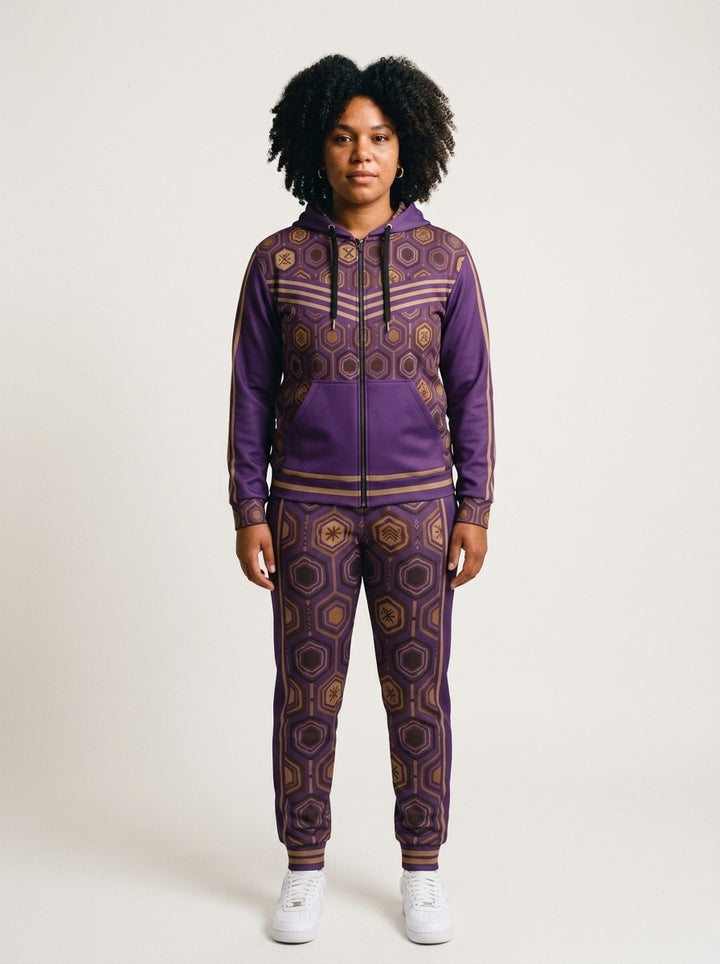 Women's tracksuit set in Ugo Purple: AnanseNova™ Zip Hoodie + Joggers on model, front view, bronze hexagon print with chevron chest stripes and full-leg jogger print | SunBorn