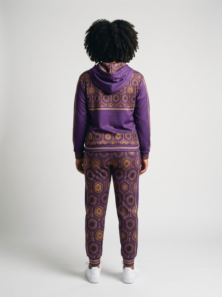 Back view of the AnanseNova™ women's Zip Hoodie + Joggers set in Ugo Purple on model, hexagon back yoke, bronze sleeve stripes and printed joggers | SunBorn