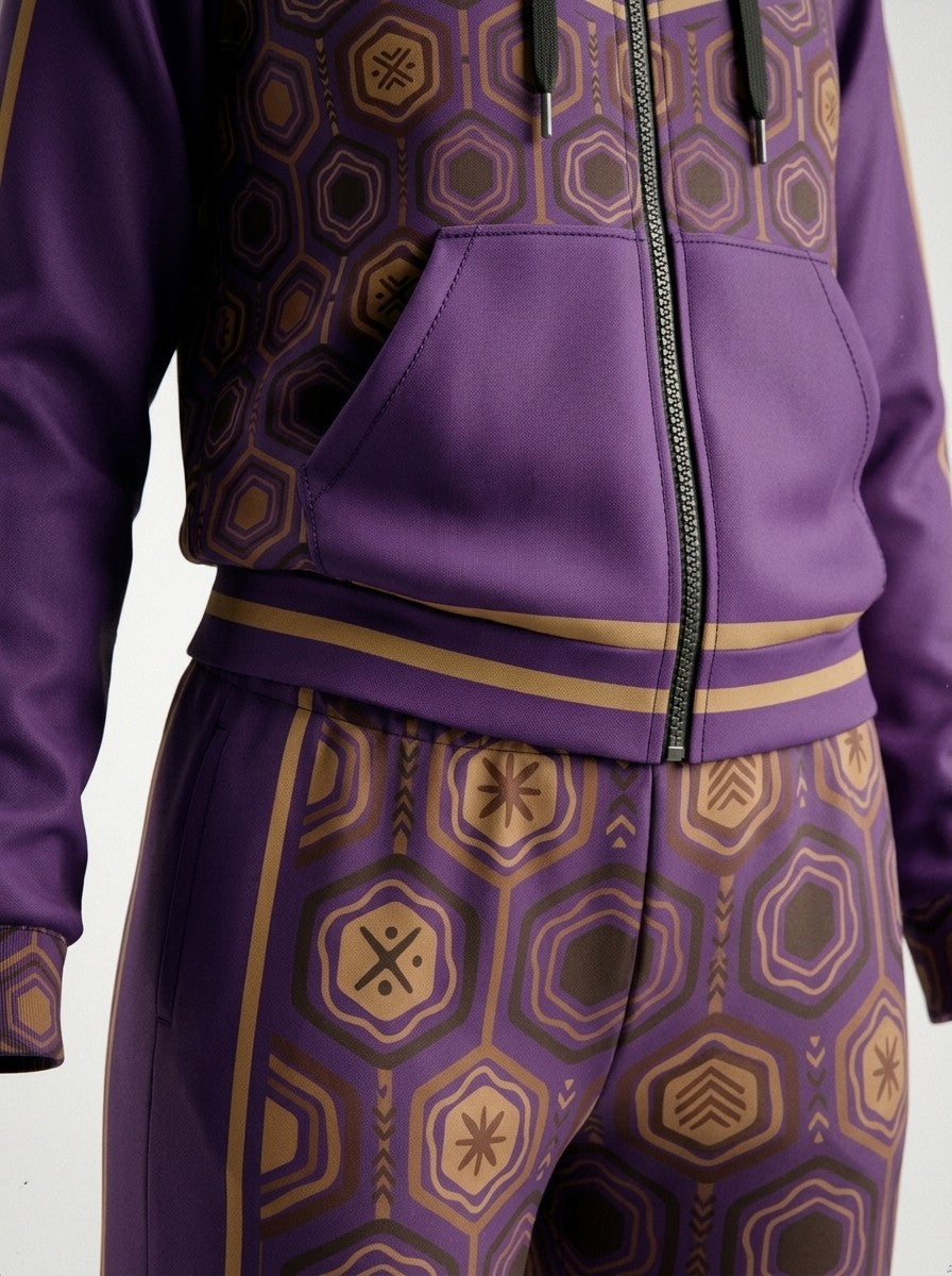 Close-up of the Ugo Purple AnanseNova™ women's set: zip hoodie pocket, bronze-striped hem and sublimation hexagon print on AkomaDrive™ fleece joggers | SunBorn