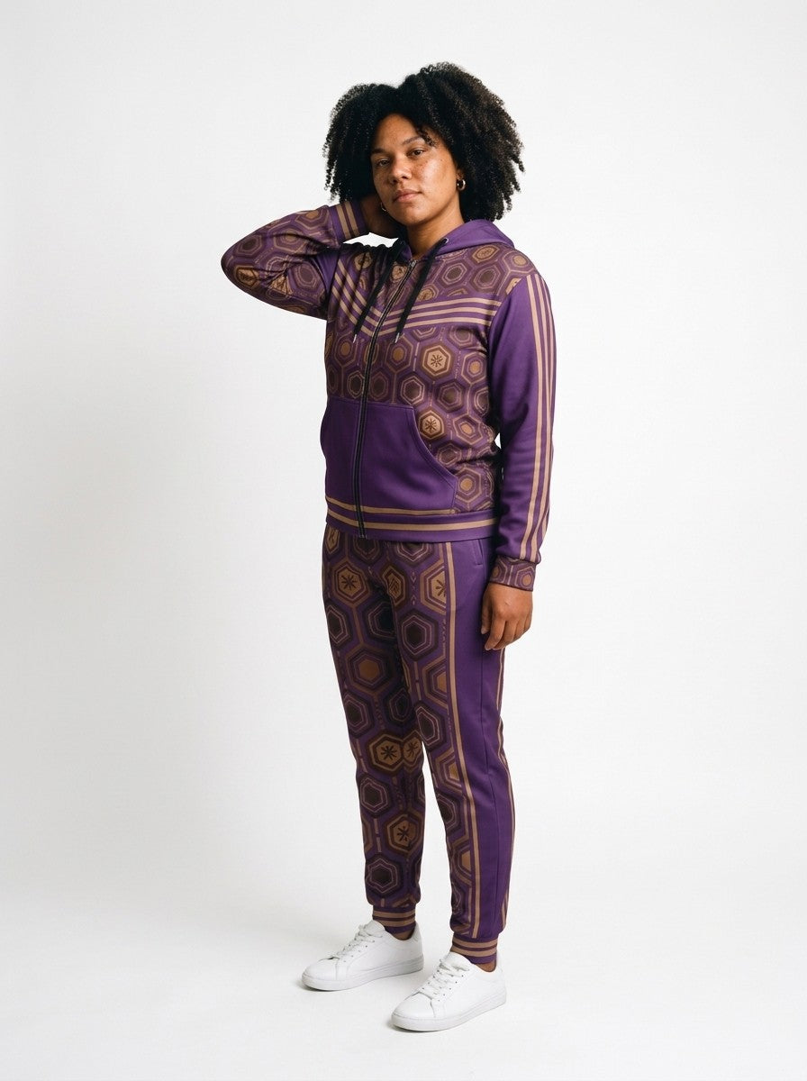 Three-quarter left view of the Ugo Purple AnanseNova™ women's Zip Hoodie + Joggers set on model, showing the jogger side panel and twin bronze pinstripes | SunBorn