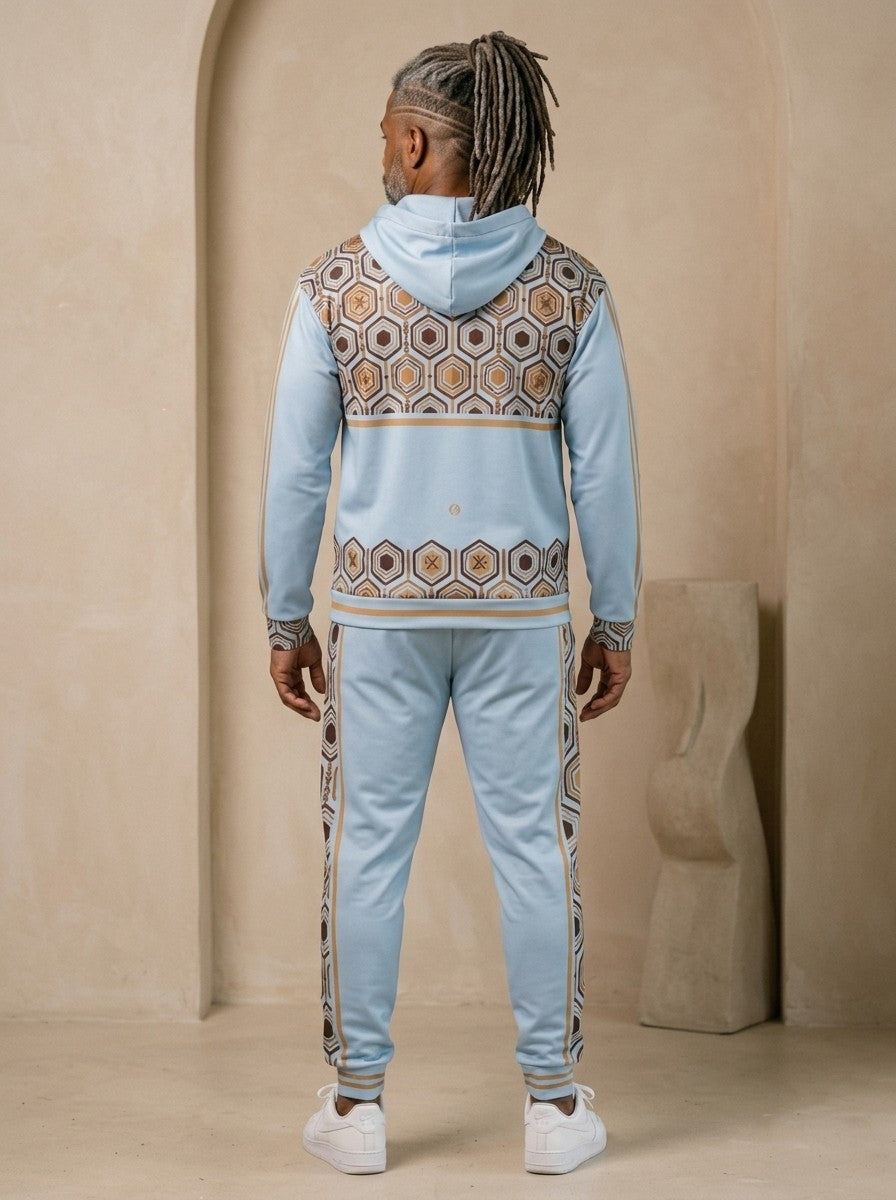 AnanseNova™ Zip Hoodie + Joggers Set in Igwe Blue, back view on model showing the hexagon print yoke and hem band and the joggers' side stripes