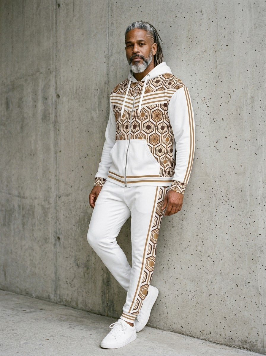 Man leaning against a concrete wall wearing the AnanseNova™ Zip Hoodie + Joggers Set in Ocha White with white sneakers