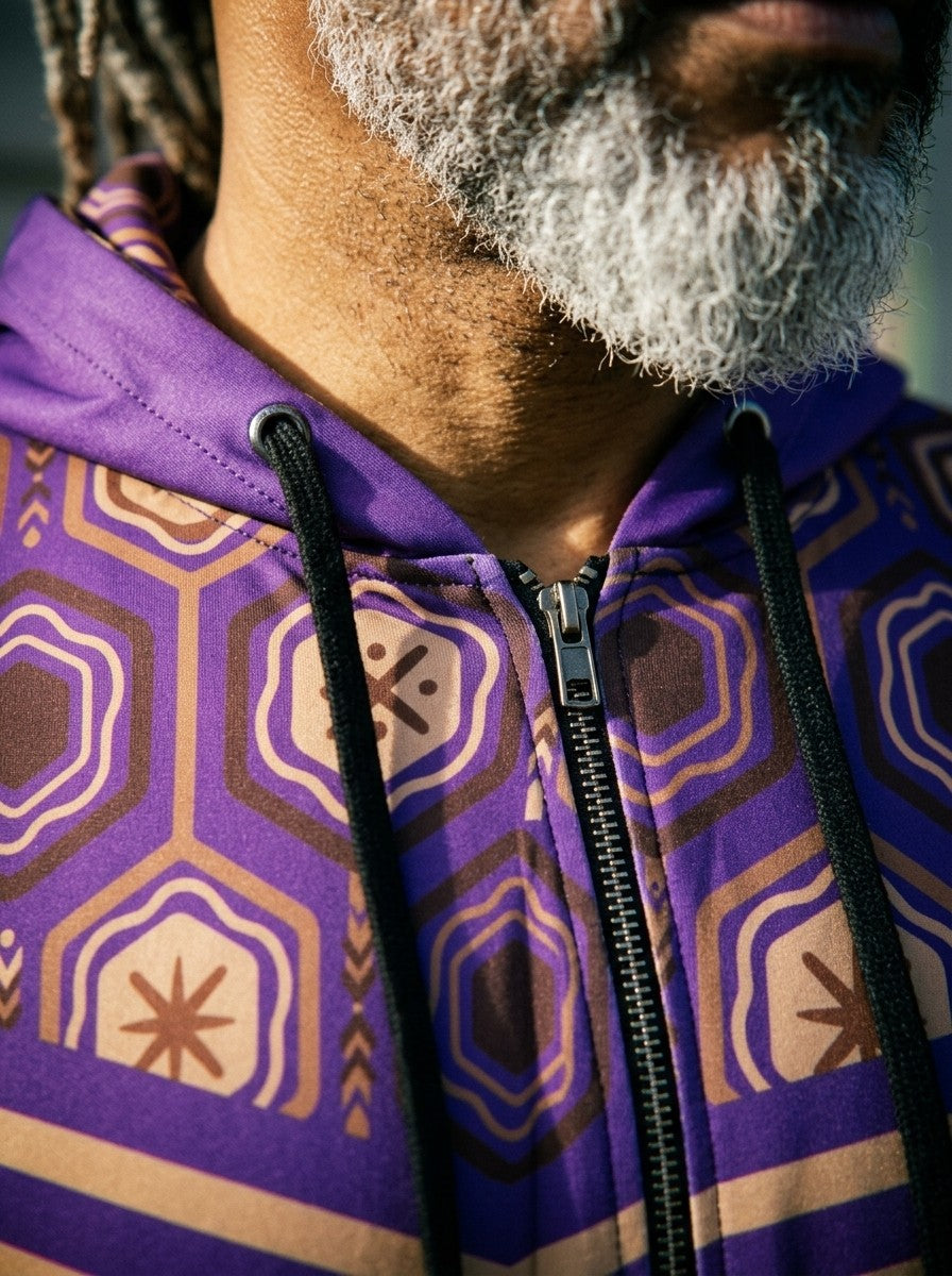 Close-up of the AnanseNova™ Zip Hoodie in Ugo Purple: printed hood lining, drawcords, metal zip and the hexagon and stripe chest print