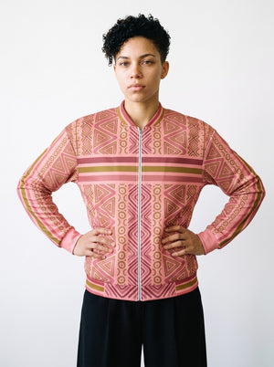 Model wearing the SunBorn N'Donso™ Bomber Jacket in Eze Pink, front view: Hunter's Road print, chest stripe band, ribbed baseball collar