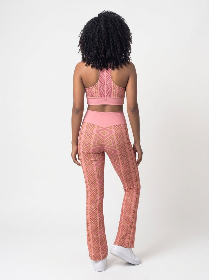 Back view of the N'Donso™ Bra + Flare Leggings Set in Adaeze Pink showing the racerback bra and the flared hem