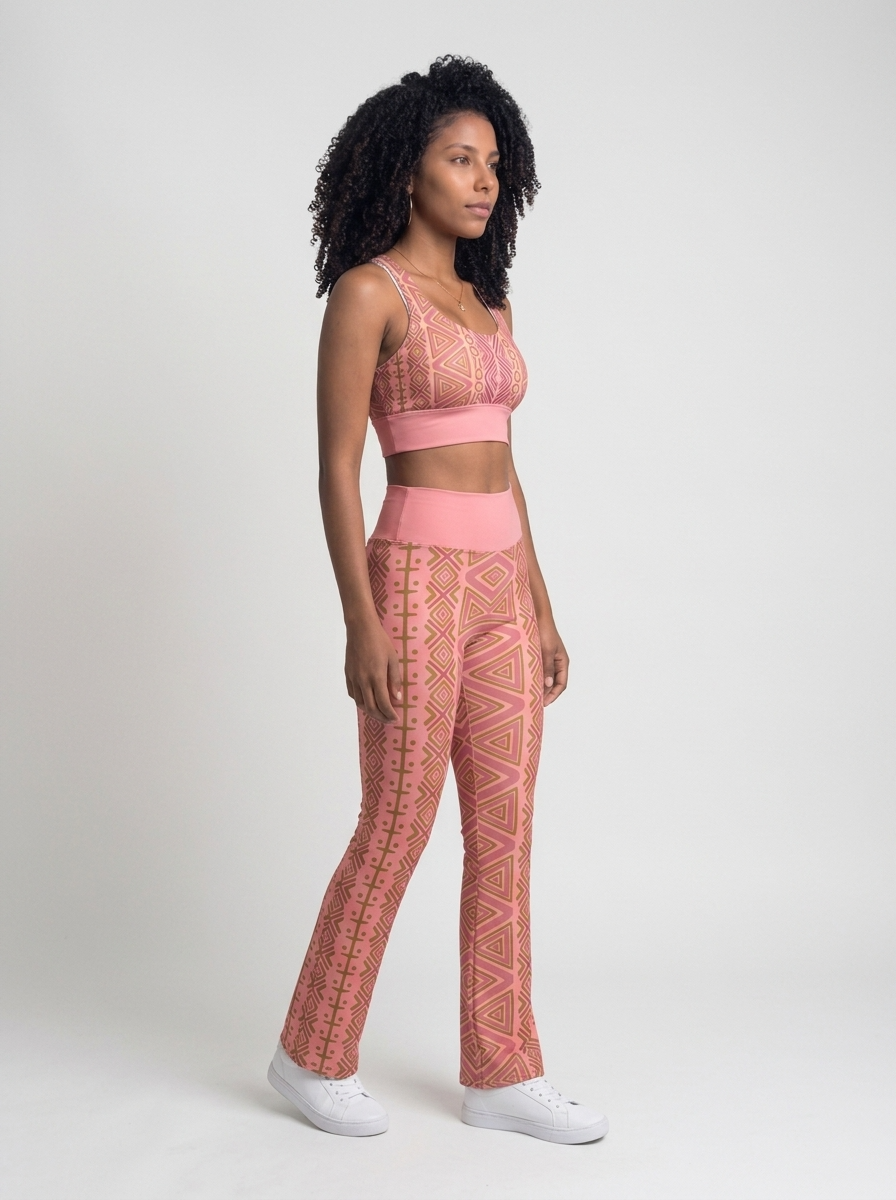 Three-quarter right view of the N'Donso™ Bra + Flare Leggings Set in Adaeze Pink