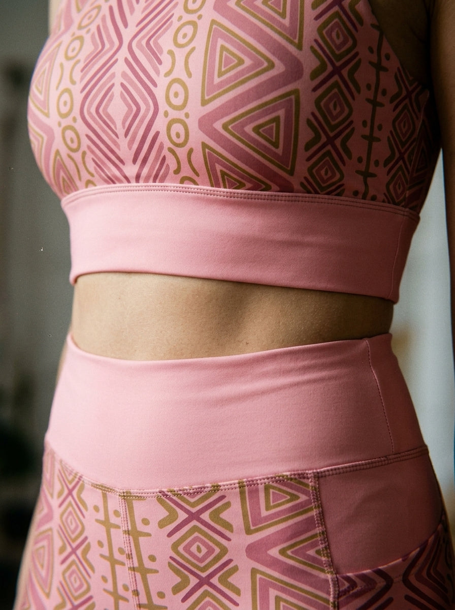 Close-up of the N'Donso™ bra underband and the high-rise leggings waistband in Adaeze Pink