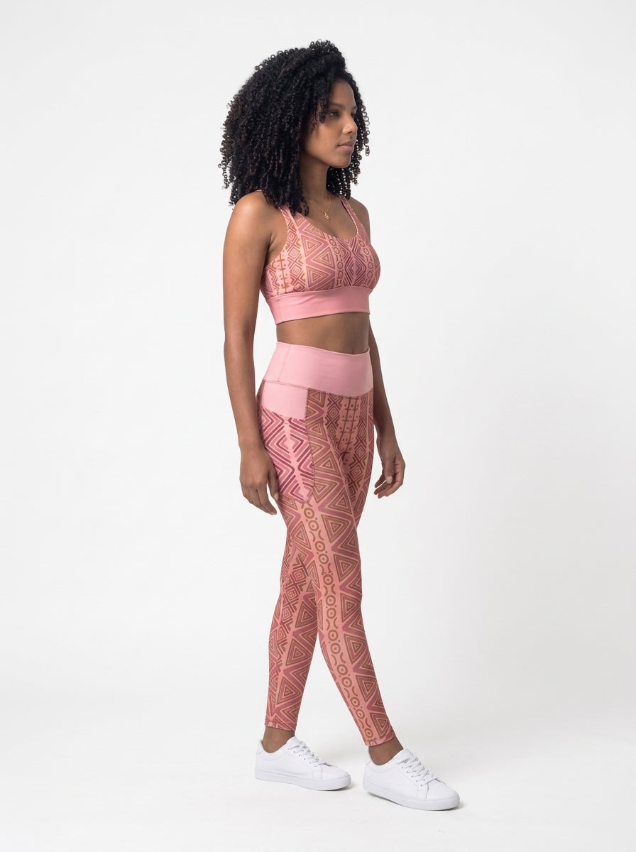 Three-quarter right view of the N'Donso™ Bra + Pocket Leggings Set in Adaeze Pink