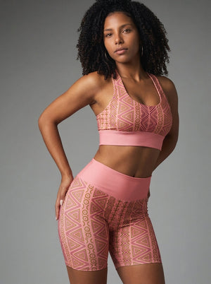 Front view of the N'Donso™ Bra + Biker Shorts Set in Adaeze Pink: Hunter's Road print longline sports bra and high-rise biker shorts by SunBorn
