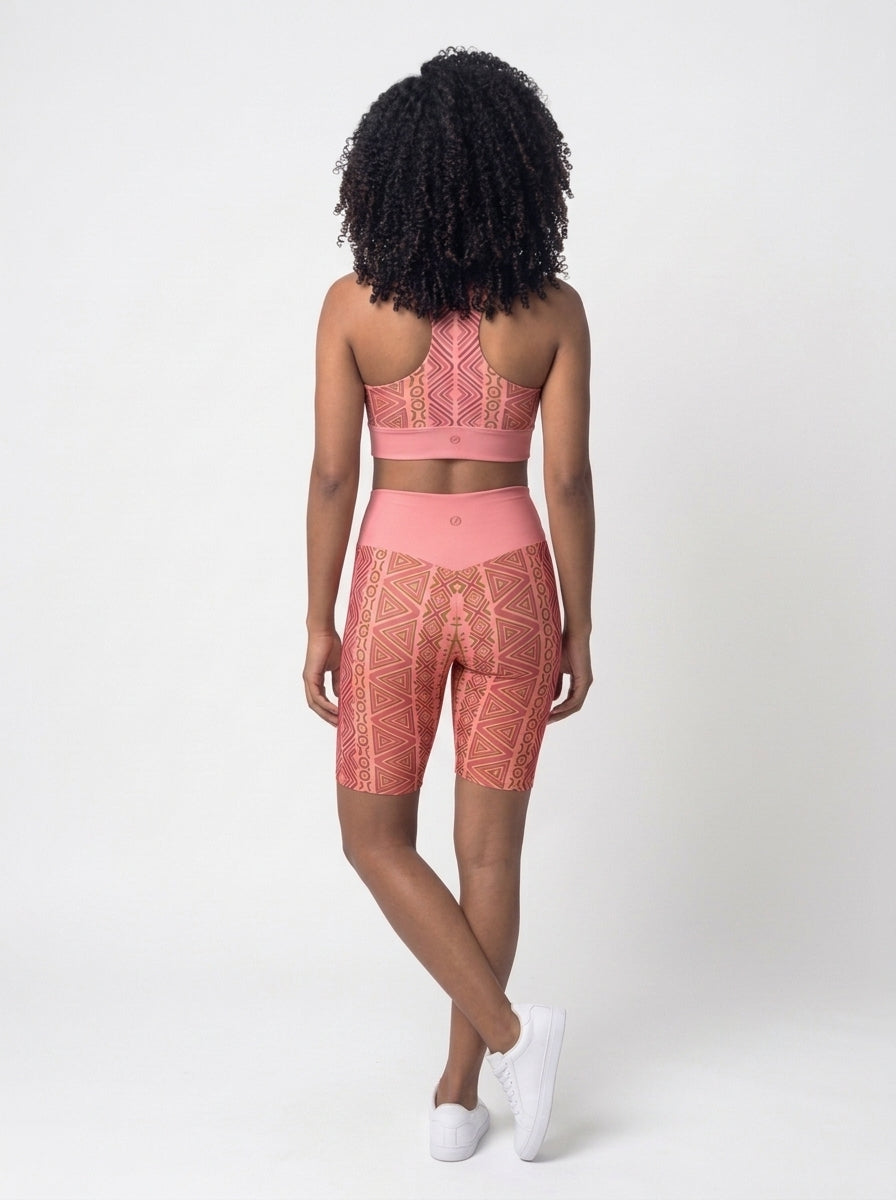 Back view of the N'Donso™ Bra + Biker Shorts Set in Adaeze Pink showing the racerback bra and solid high-rise waistband