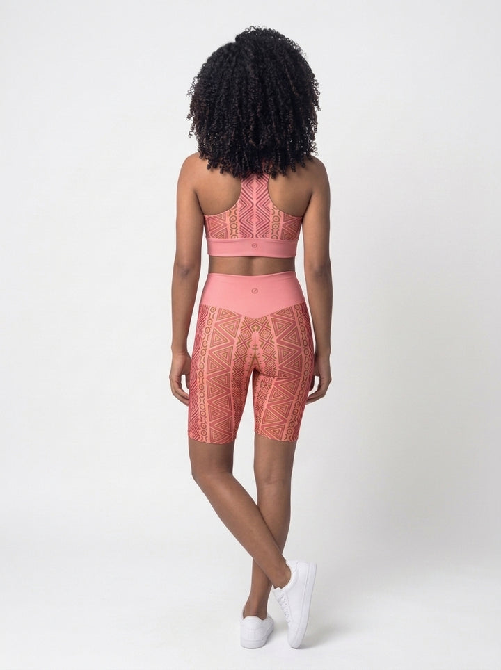 Back view of the N'Donso™ Bra + Biker Shorts Set in Adaeze Pink showing the racerback bra and solid high-rise waistband