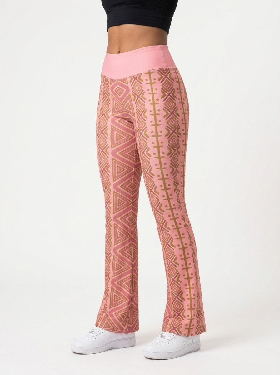 SunBorn N'Donso™ Flare Leggings in Adaeze Pink, three-quarter left view on model showing the side stripe-and-dot column