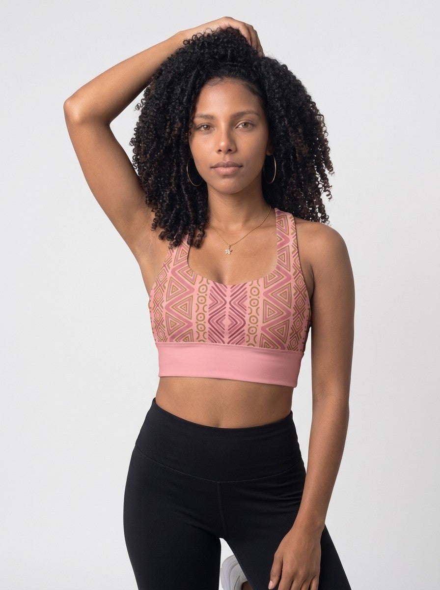 Woman wearing the SunBorn N'Donso™ Longline Bra in Adaeze Pink, front view: scoop neck, Hunter's Road print and solid pink underband