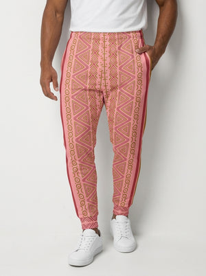 Man wearing SunBorn N'Donso™ Men's Joggers in Eze Pink, front view: Hunter's Road print waist to cuff with a solid side stripe