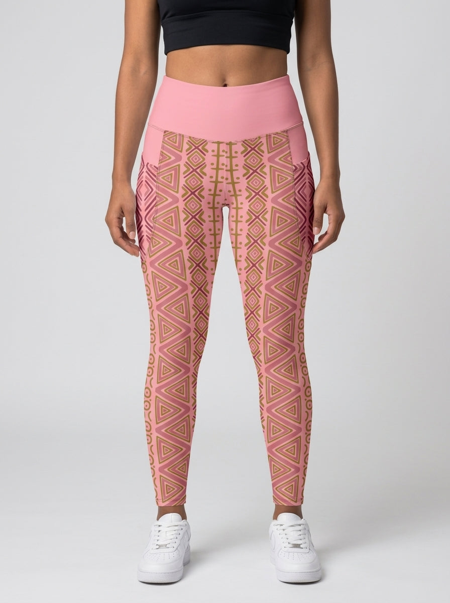Woman wearing SunBorn N'Donso™ Pocket Leggings in Adaeze Pink, front view: high-rise solid pink waistband, side pockets and Hunter's Road print to the ankle