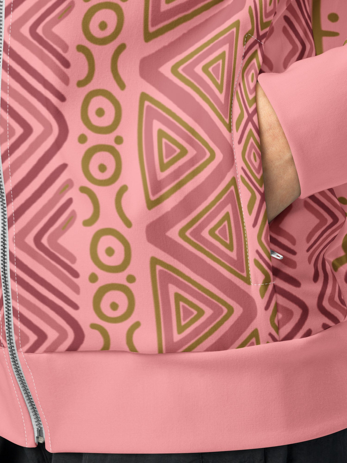 Close-up of the N'Donso™ Track Jacket in Eze Pink: zippered side pocket, ribbed cuff and hem on AkomaDrive™ recycled brushed fleece