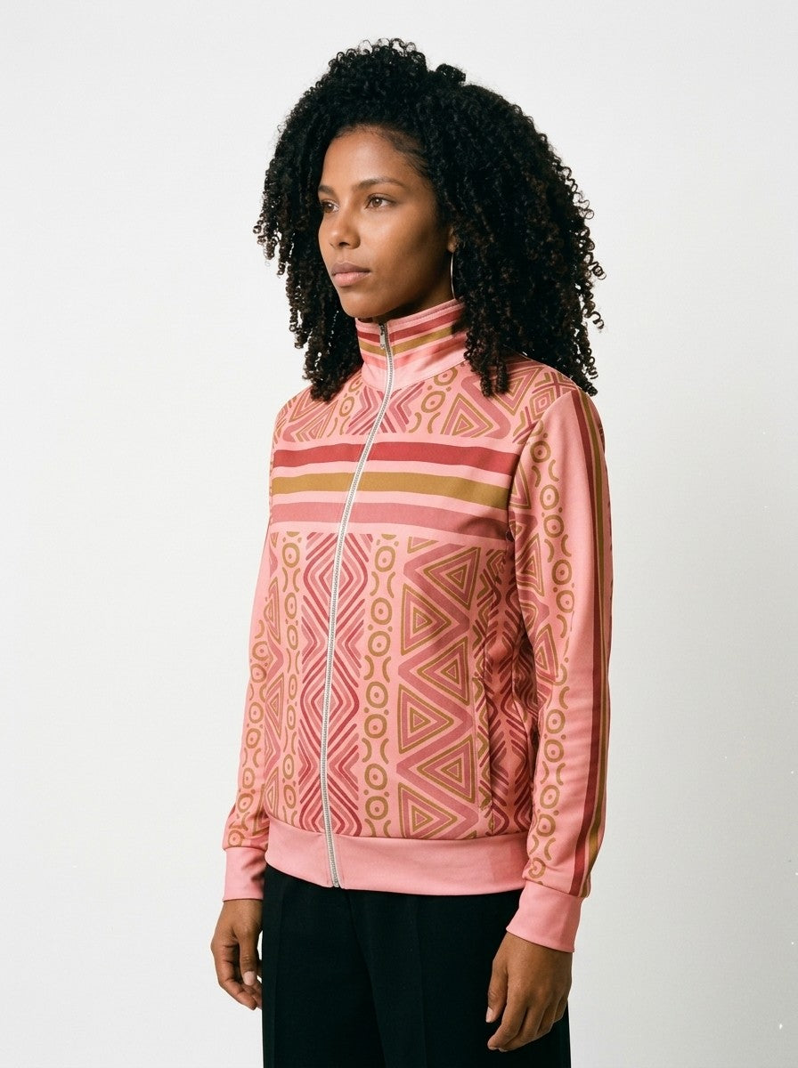 SunBorn N'Donso™ Track Jacket in Eze Pink, three-quarter left view on model with black wide-leg trousers