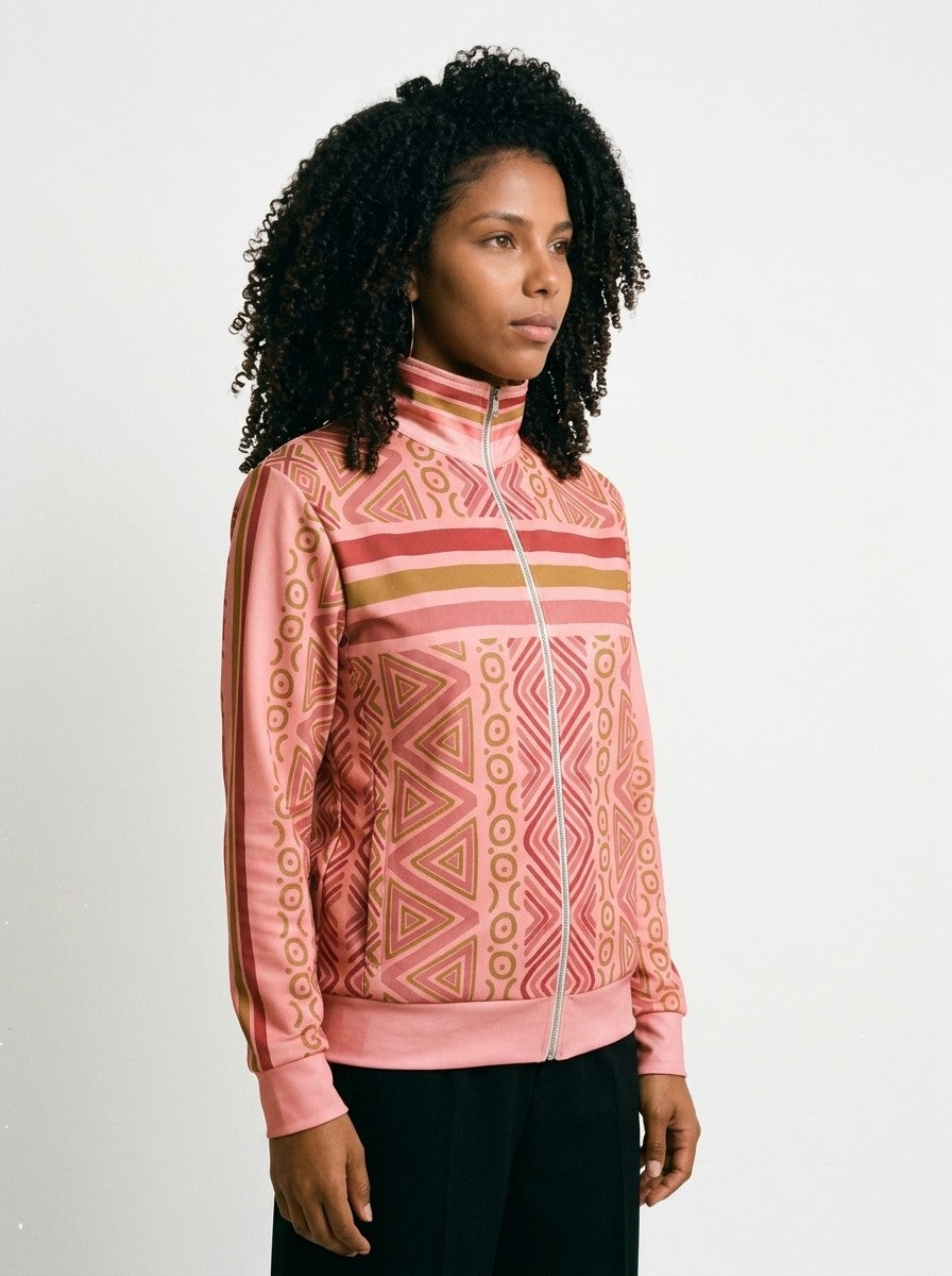 SunBorn N'Donso™ Track Jacket in Eze Pink, three-quarter right view on model showing the full-length sleeve stripe