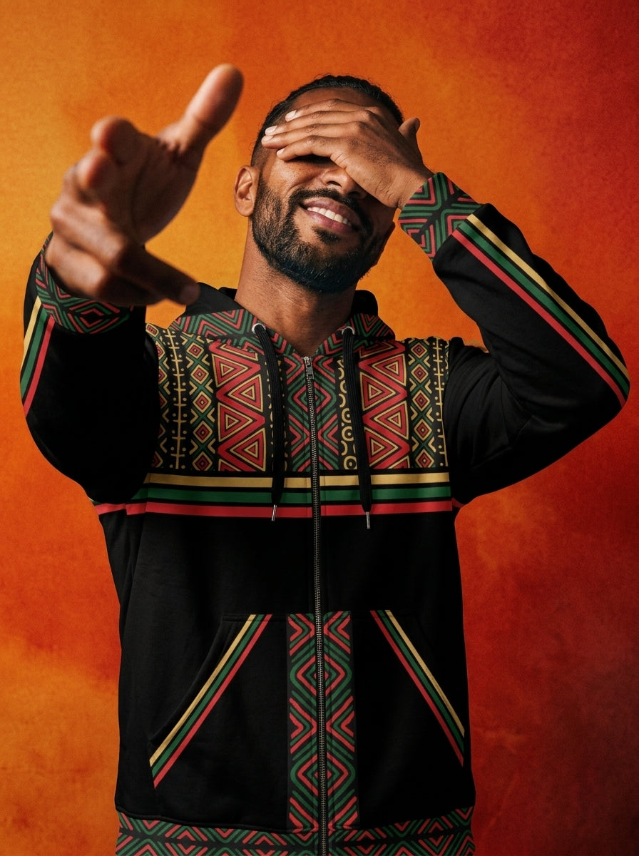Man laughing against an orange backdrop in the SunBorn N'Donso™ Zip Hoodie in Uhie Red, pointing at the camera
