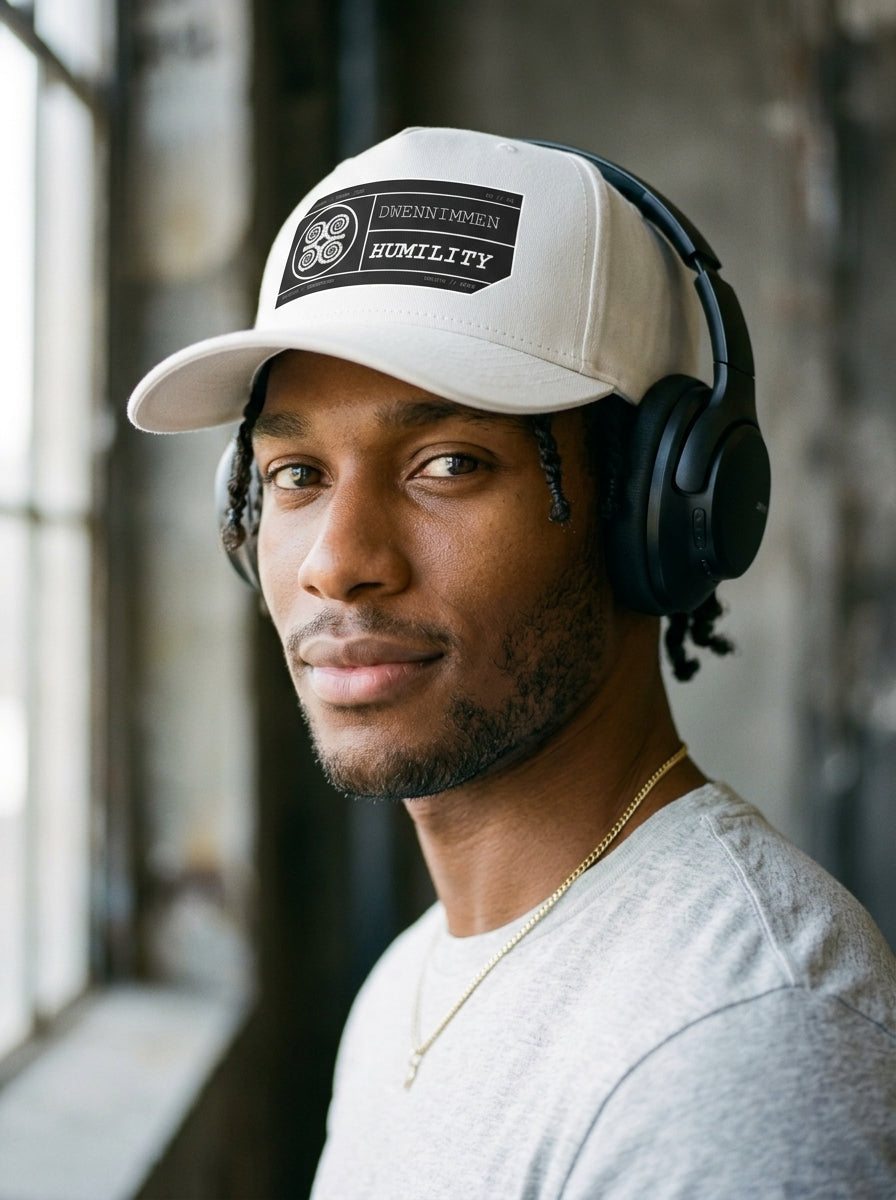 Adinkra // Humility Cap in Oji Black — styled with headphones and shades — SunBorn
