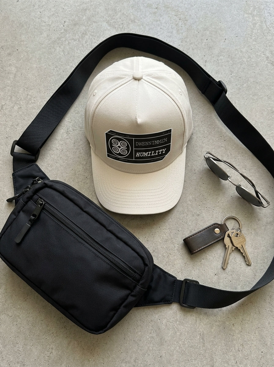 Adinkra // Humility Cap in Oji Black — styled with a bag — SunBorn