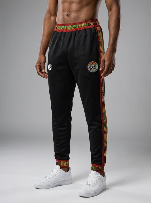 Black jogger pants with colorful trim and a logo on a gray background