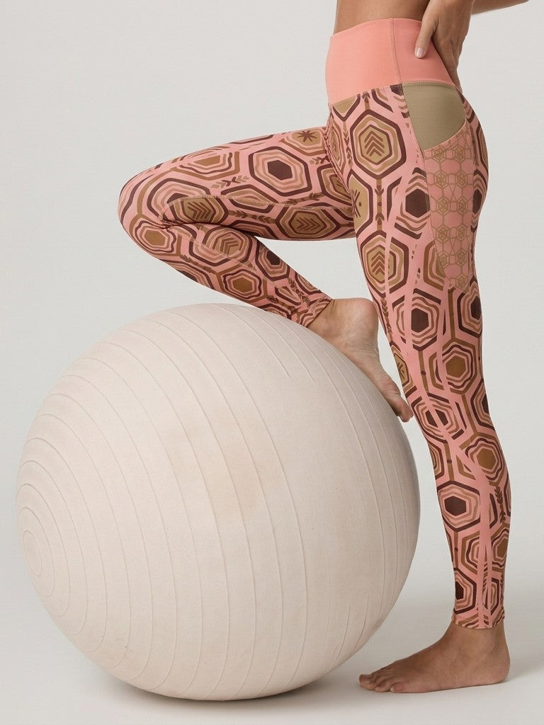 AnanseNova™ Pocket Leggings in Adaeze Pink, leg raised on an exercise ball showing the side pocket