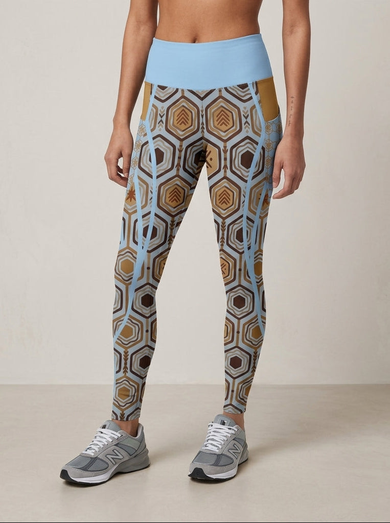 AnanseNova™ Pocket Leggings in Igwe Blue, front view from the waist down — hexagon print with solid high waistband