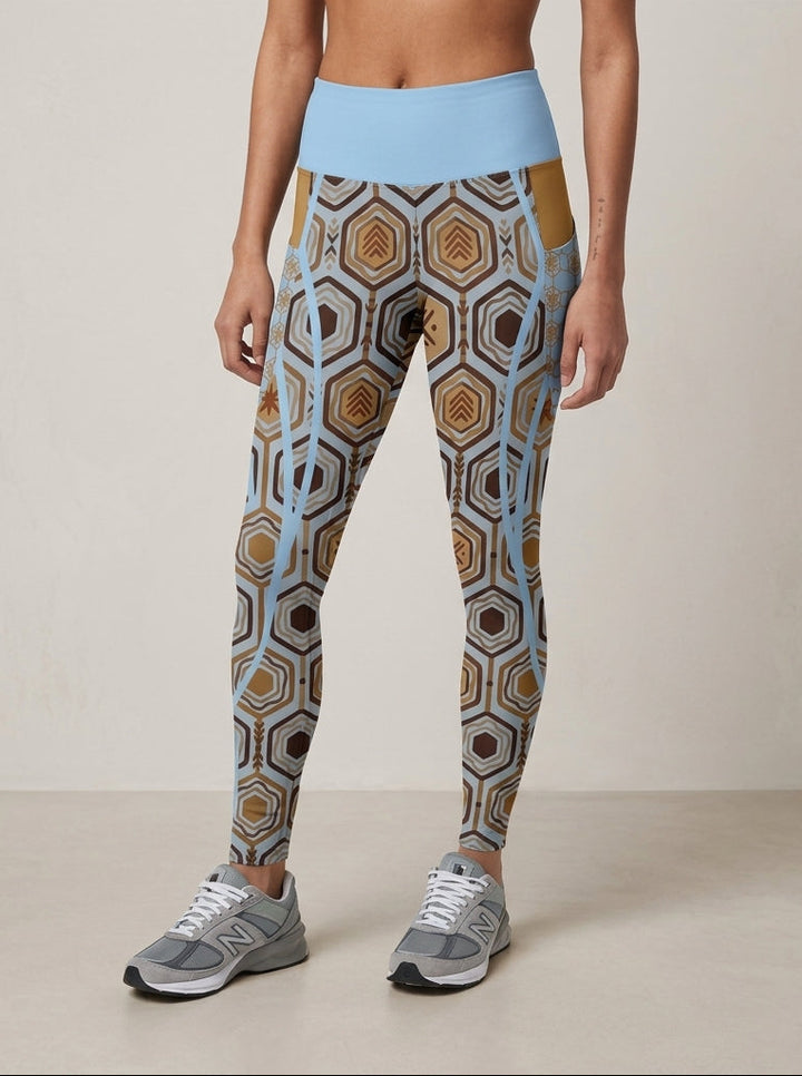 AnanseNova™ Pocket Leggings in Igwe Blue, front view from the waist down — hexagon print with solid high waistband