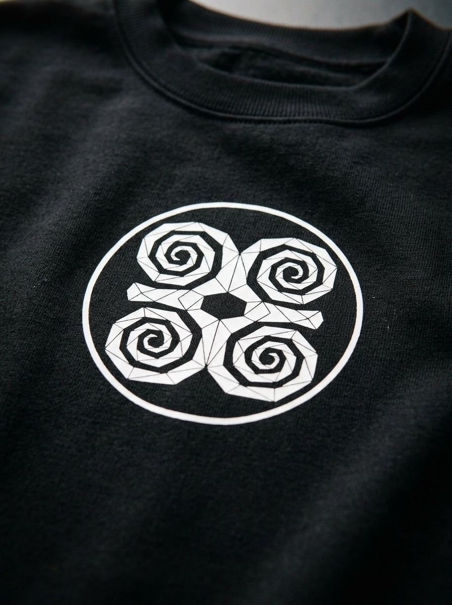SunBorn Adinkra // Humility Sweatshirt in Oji Black, macro detail of the center-chest Dwennimmen badge print