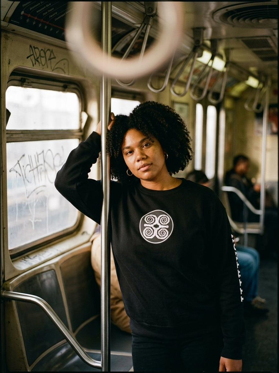 SunBorn Adinkra // Humility Sweatshirt in Oji Black, styled in a real-world lifestyle setting