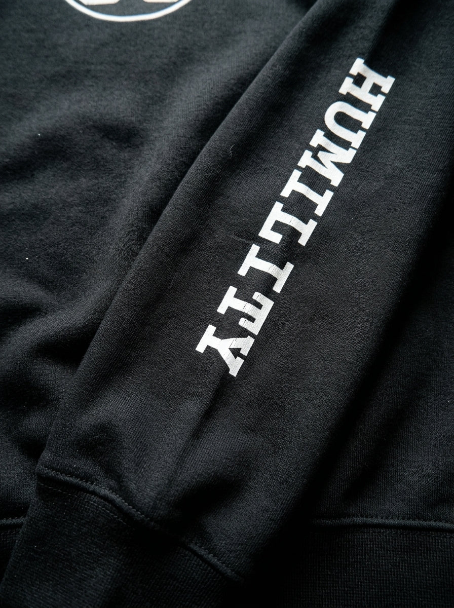 SunBorn Adinkra // Humility Sweatshirt in Oji Black, macro detail of the sleeve wordmark print