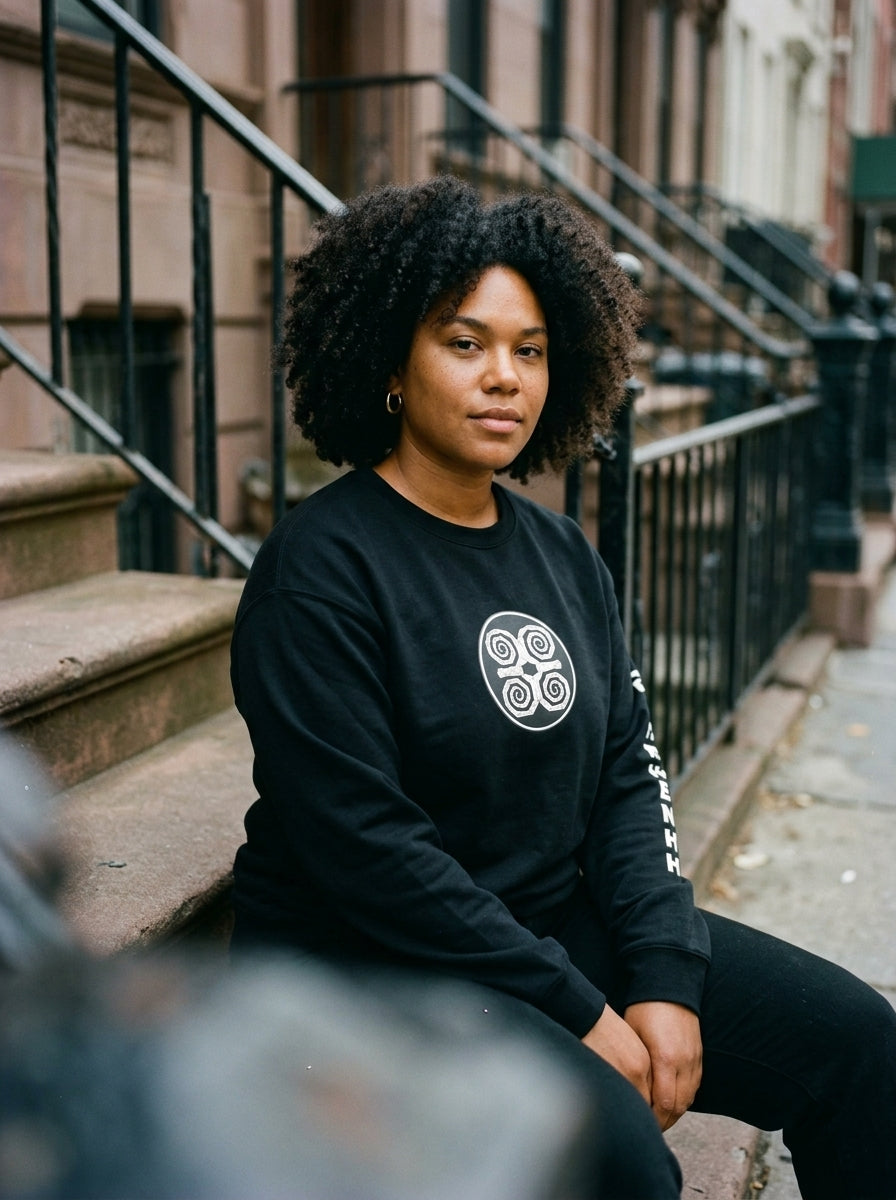SunBorn Adinkra // Humility Sweatshirt in Oji Black, on-model fit check styled in a real-world lifestyle setting