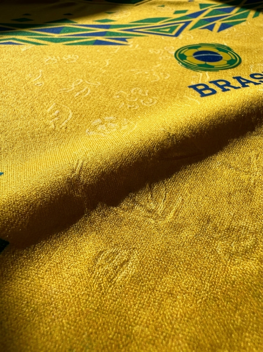 Brasil '26 Canarinho Edition Jersey — macro detail of the Afro-Brasilian source code amplified by SunBorn — image 5