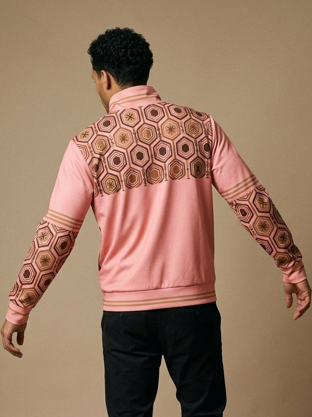 AnanseNova™ Statement Track Jacket in Eze Pink — back view on model, hexagon print across the upper back and shoulders with striped cuffs and hem