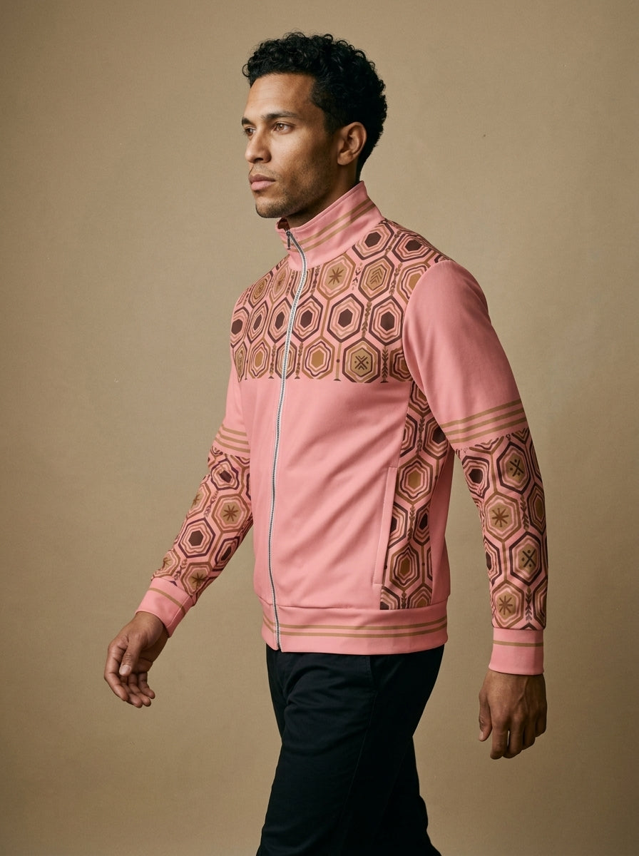 AnanseNova™ Statement Track Jacket in Eze Pink — three-quarter left view on model, full-zip track jacket with hexagon yoke and forearm panels