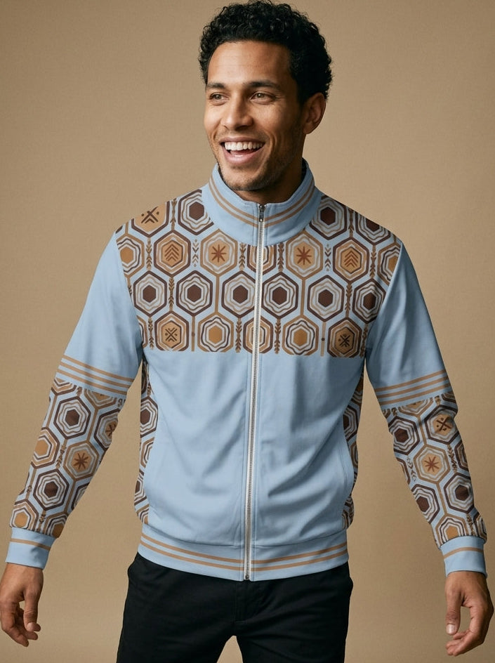AnanseNova™ Statement Track Jacket in Igwe Blue — front view on model, hexagon web-cell yoke, stand collar and triple-stripe trim on a full-zip track jacket