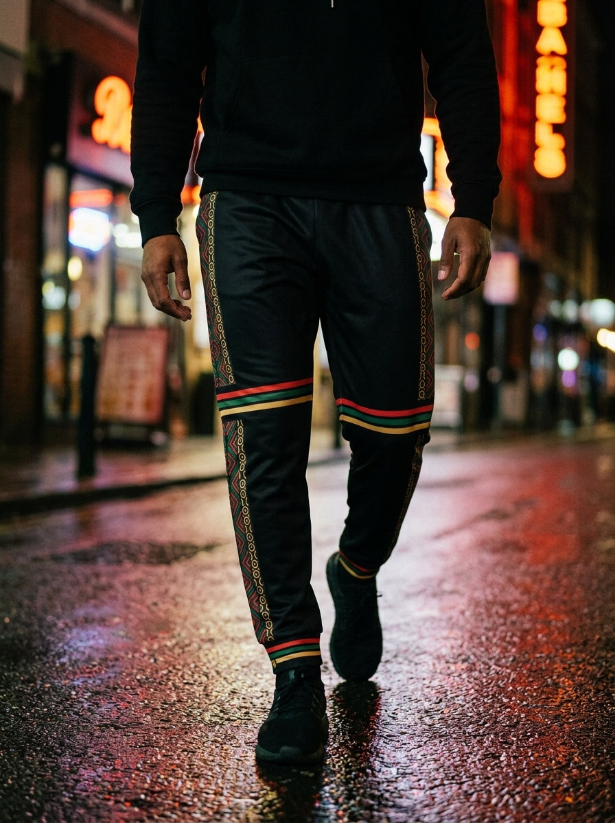 Model in the N'Donso™ Men's Joggers (Uhie Red), lifestyle shot mid-stride in transit.