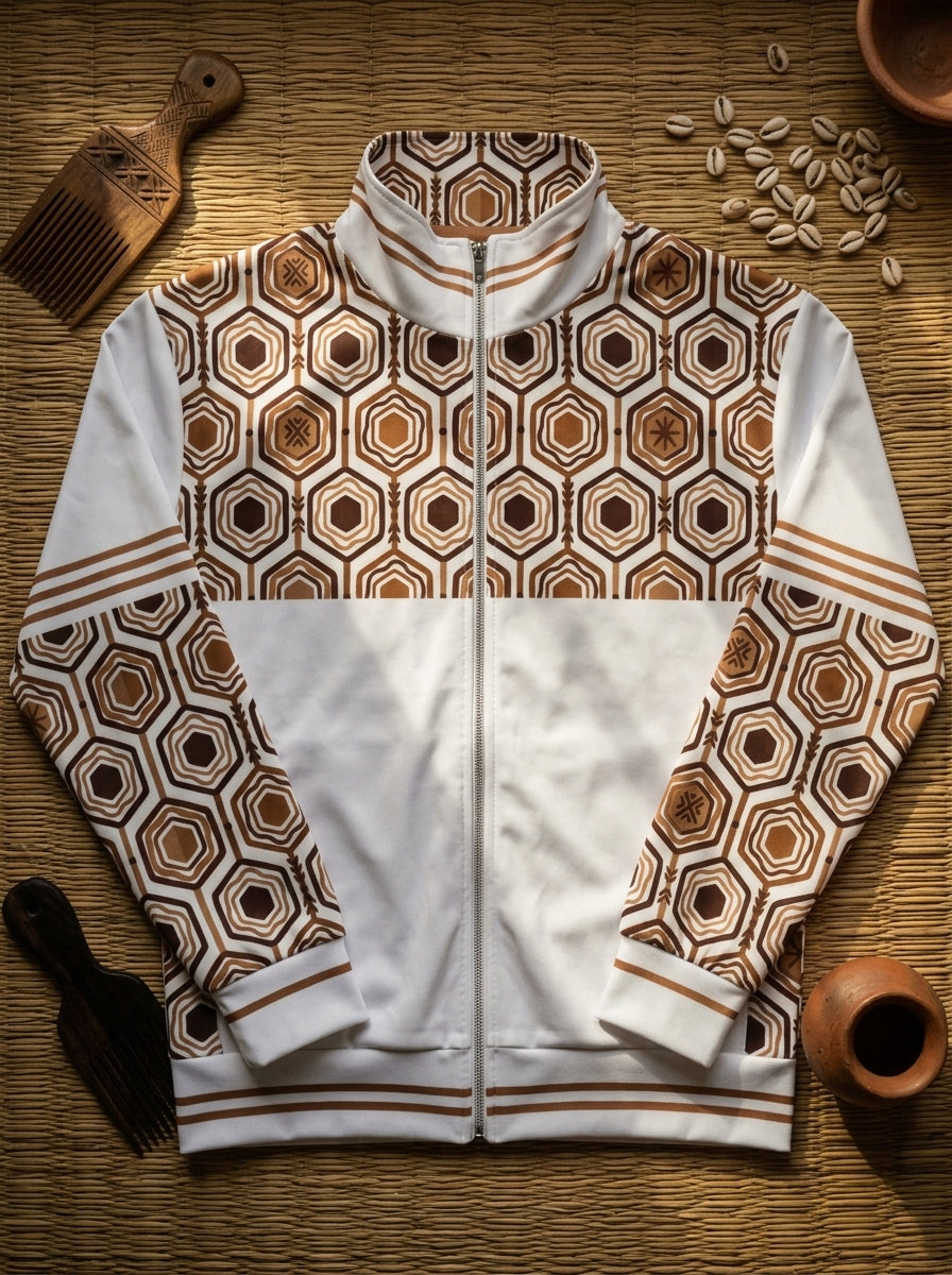 AnanseNova™ Statement Track Jacket in Ocha White — styled flat lay of the full-zip track jacket with hexagon print, laid on woven textiles