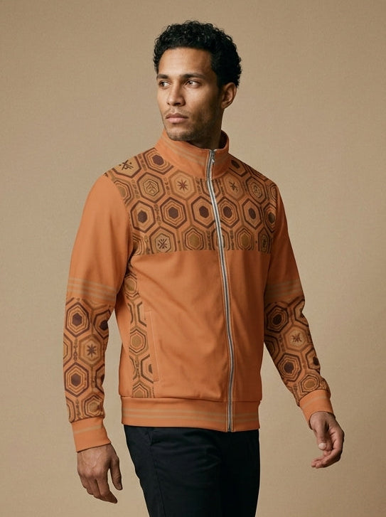 AnanseNova™ Statement Track Jacket in Sango Orange — three-quarter left view on model, full-zip track jacket with hexagon yoke and forearm panels