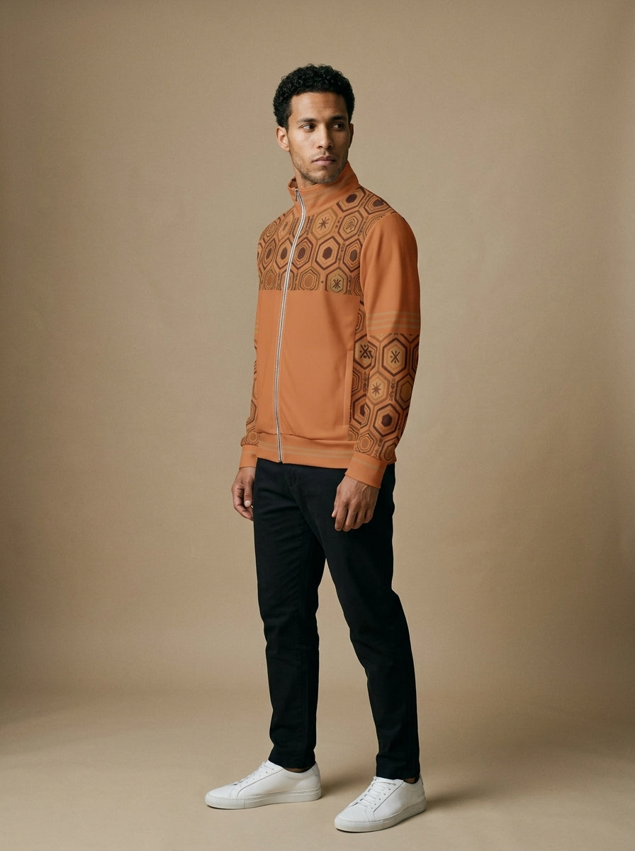 AnanseNova™ Statement Track Jacket in Sango Orange — three-quarter right view on model, full-zip track jacket with hexagon yoke and forearm panels