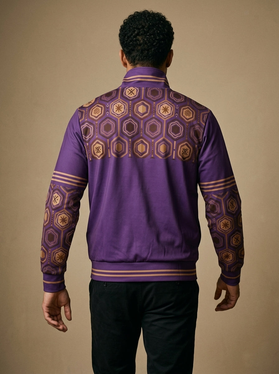 AnanseNova™ Statement Track Jacket in Ugo Purple — back view on model, hexagon print across the upper back and shoulders with striped cuffs and hem