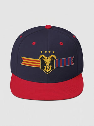 GOAT Catalan two-tone snapback in Anụnụ Blue / Uhie Red, front view — the full-colour Catalan crest on the crown: gold goat, No. 10, four stars, split Senyera and blaugrana banner.