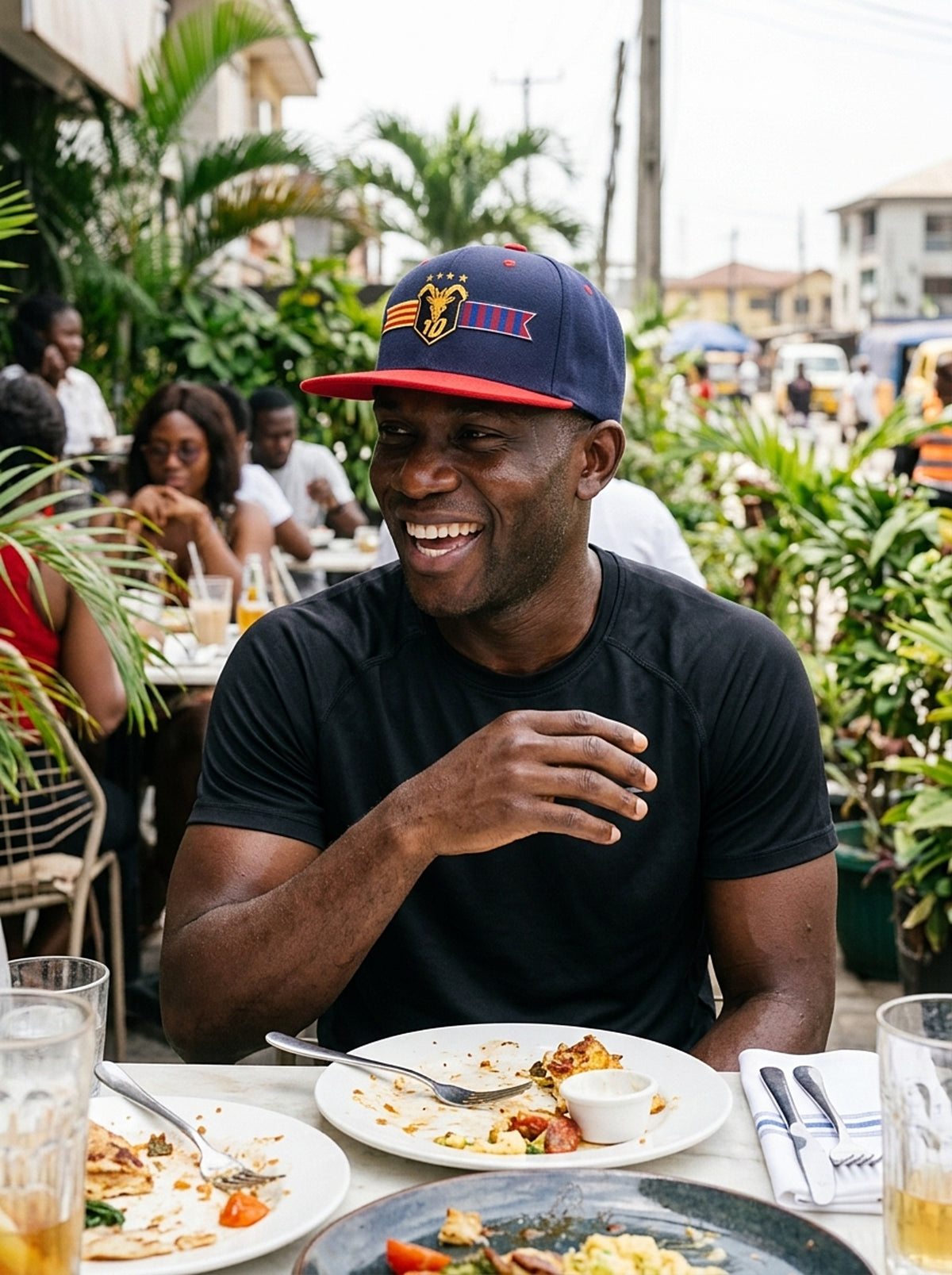 Lifestyle action shot of the GOAT Catalan two-tone snapback in Anụnụ Blue / Uhie Red.